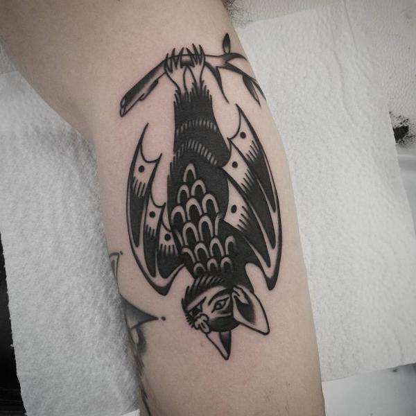 Black traditional hanging bat tattoo