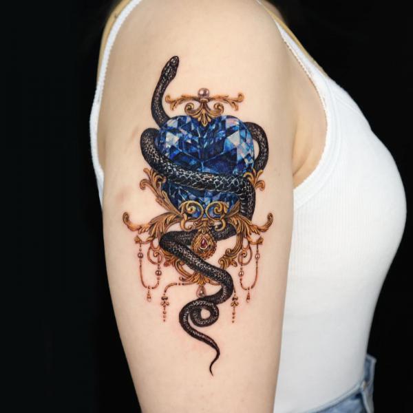 Blue diamond and black snake tattoo
