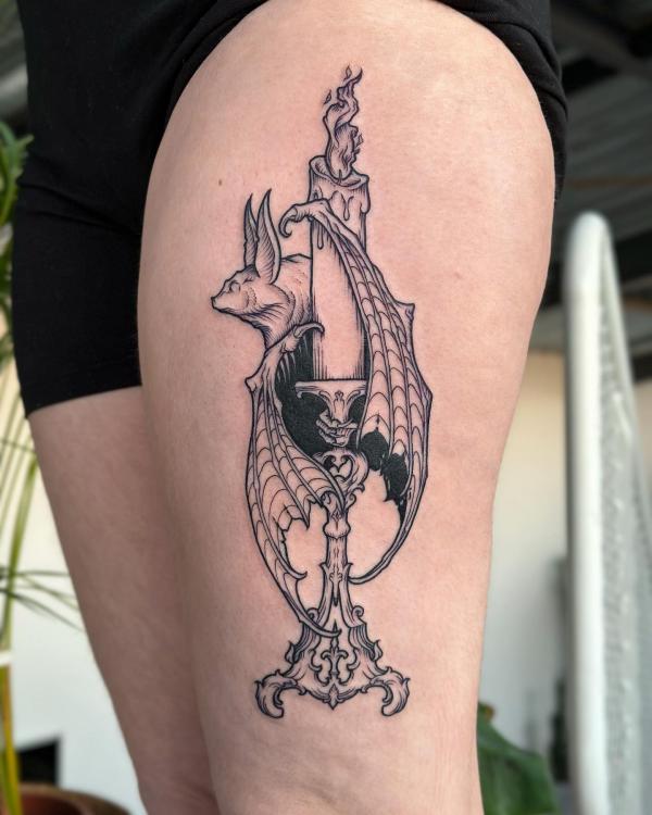 Candle surrounded by bat wings