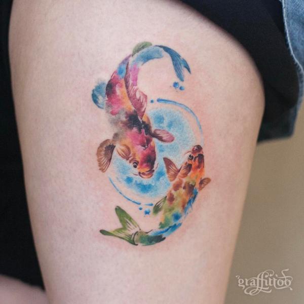 Colorful two koi fish thigh tattoo