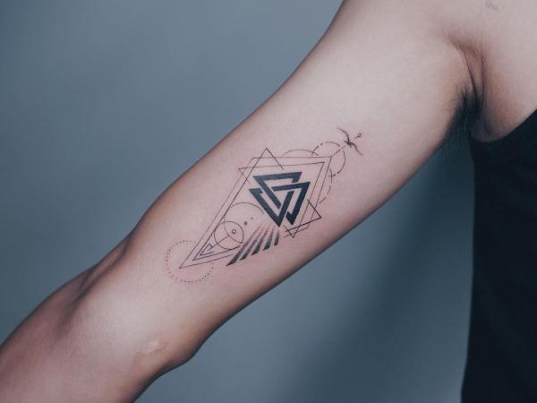 Geometric valknut bicep tattoo