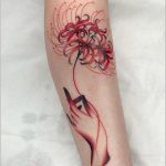 Hand holding spider lily