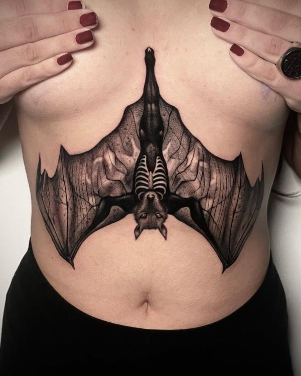 Hanging bat sternum tattoo