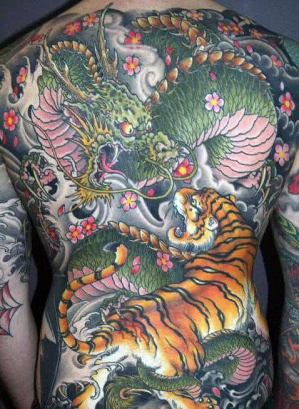 Japanese dragon and tiger fighting full back tattoo for men