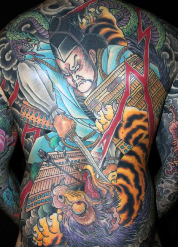 Japanese samurai stabbing a tiger with a dagger in his hand