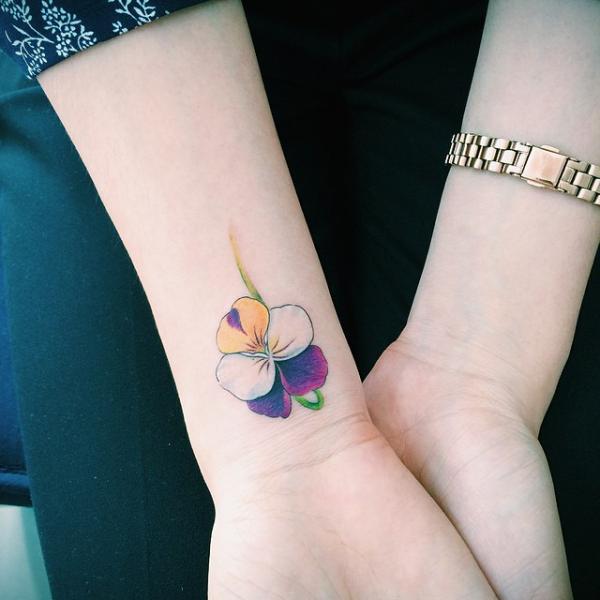 Minimalist orchid wrist tattoo
