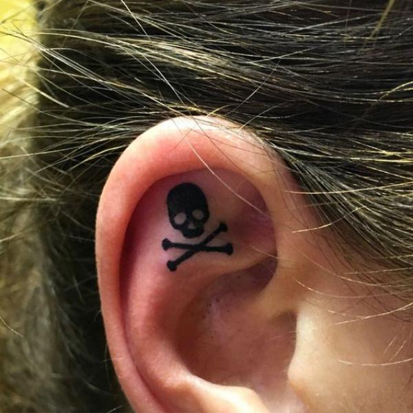 Minimalist pirate flag symbol ear tattoo