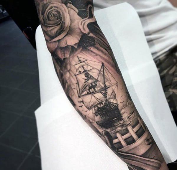 Sketch work boat tattoo on the chest and upper arm.
