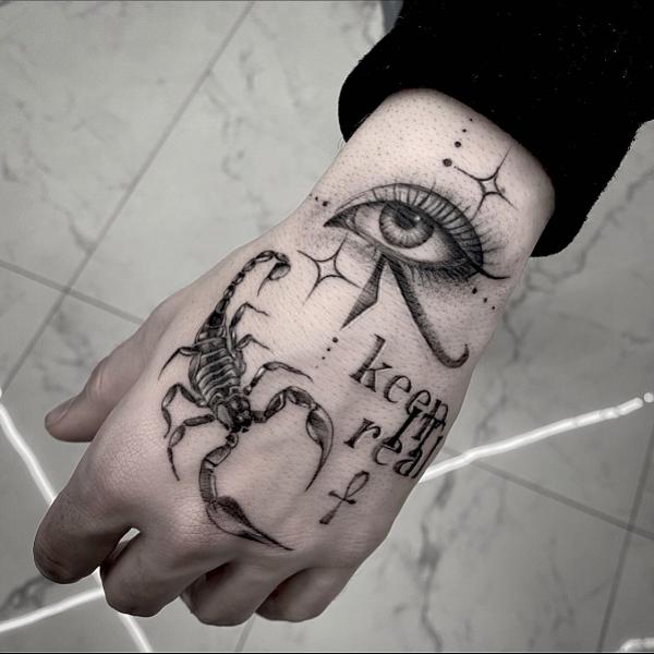 Scorpion and eye with words keep it real