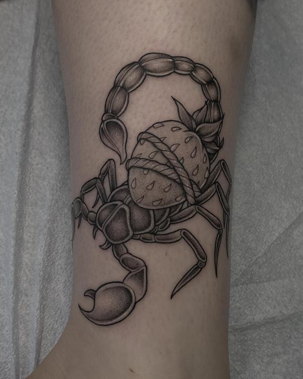 Scorpion carrying a strawberry