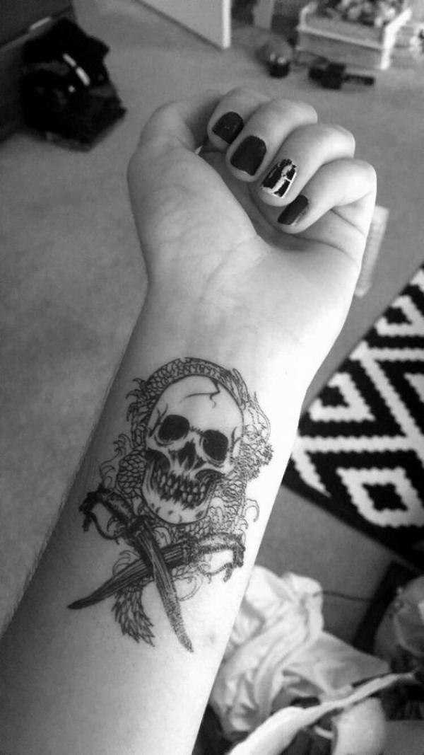 Skull encircled with dragon and crossed daggers