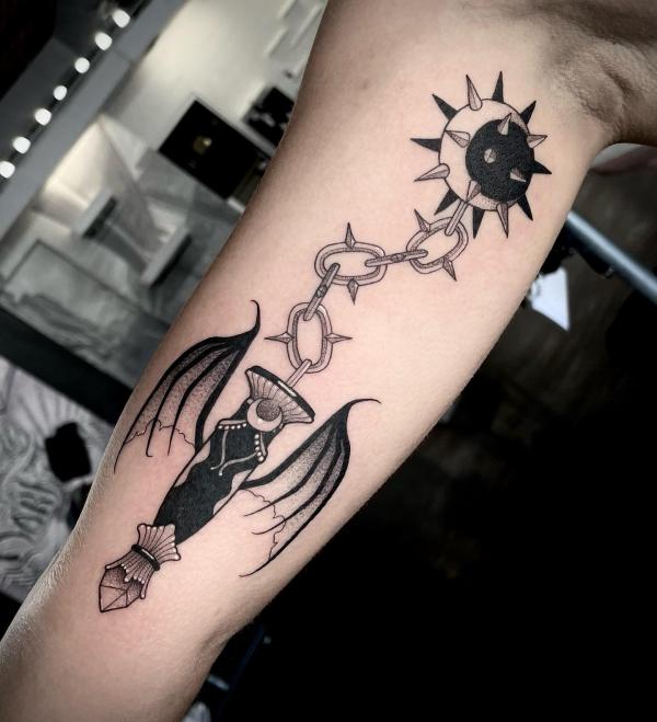 Stylized bat connecting to moon with thorn chain