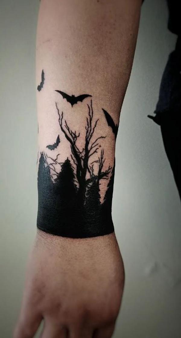 Trees with bats silhouette tattoo