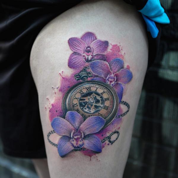 Watercolor pocket watch with orchid thigh tattoo