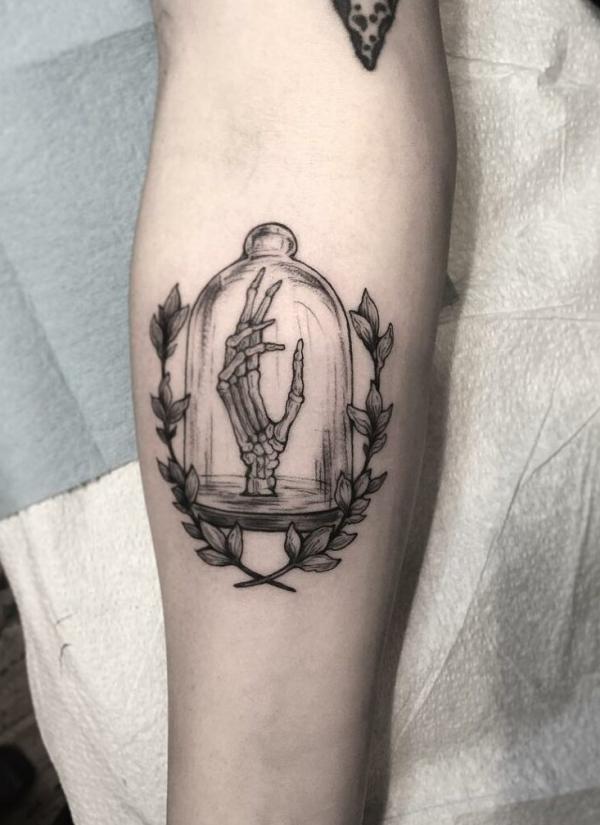 A skeleton hand in a bottle