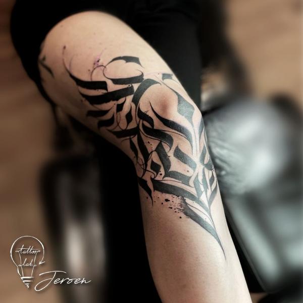 Black Line strokes knee tattoo