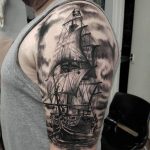 Black and grey pirate ship tattoo