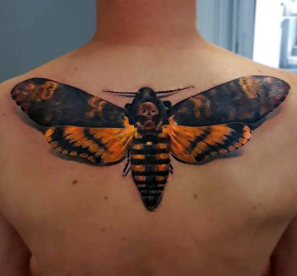Black and orange Death hawkmoth tattoo on back