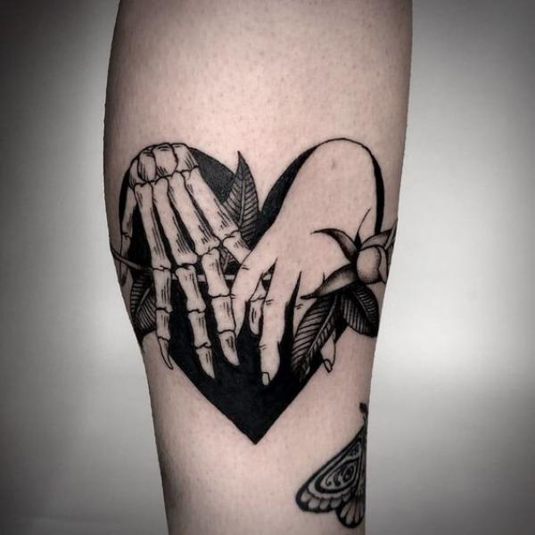 Black and white traditional skeleton hand in love symbol