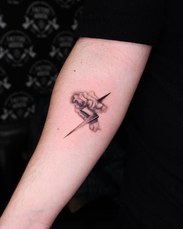 Cloud and lightning bolt inner elbow tattoo