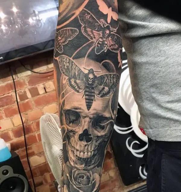 Death moth and skull tattoo