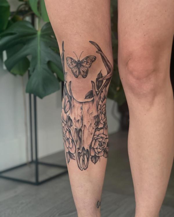 Deer skull and butterfly tattoo