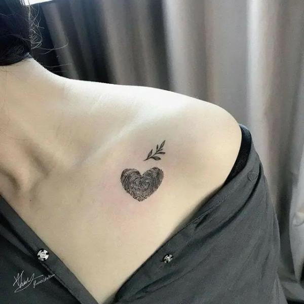Fingerprint heart and leaf clavicle tattoo