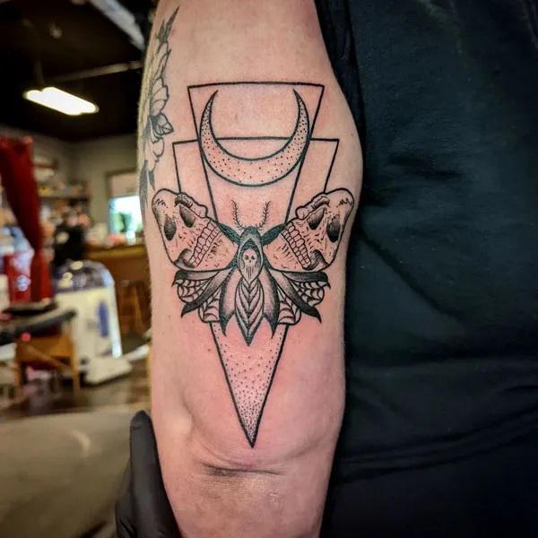 Geometric double skull moth tattoo