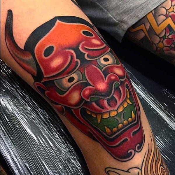 Hannya mask knee tattoo
