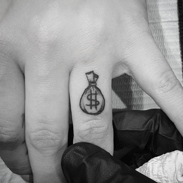 Money bag finger tattoo