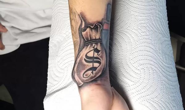 Money bag wrist tattoo
