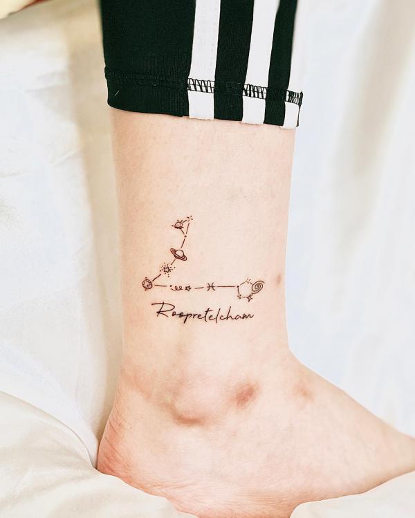 Pisces constellation ankle tattoo with word Roopretelcham