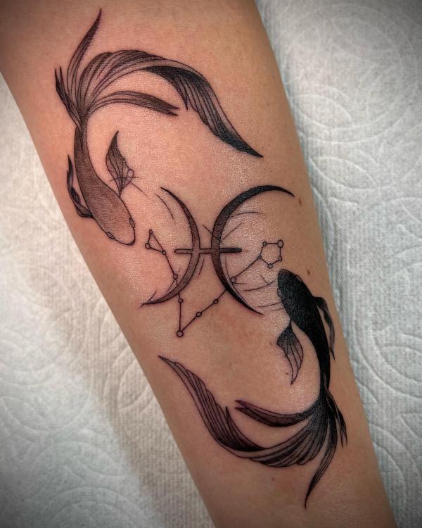 Pisces forearm tattoo