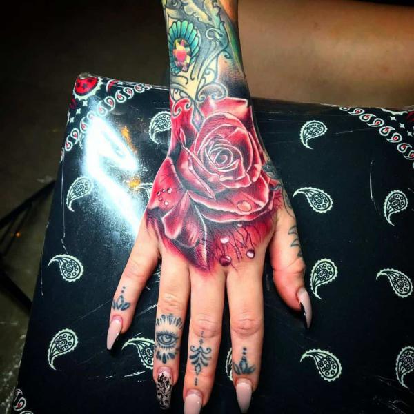 Red rose hand tattoo