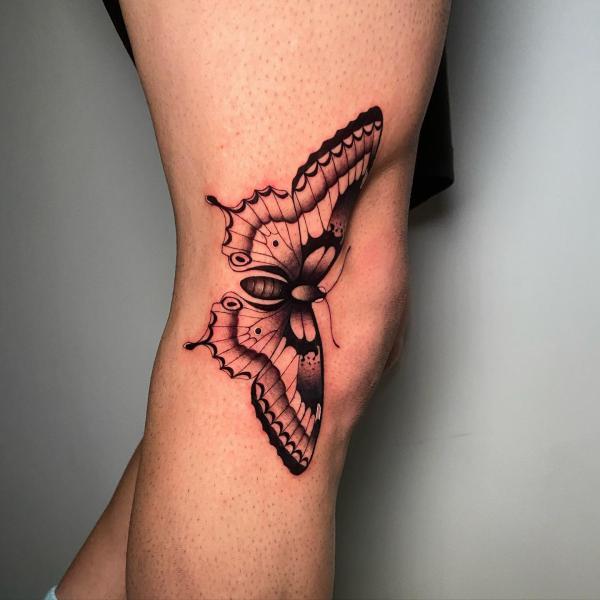 Retro butterfly tattoo on the side of knee