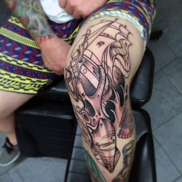 Sailing boat and squid knee tattoo