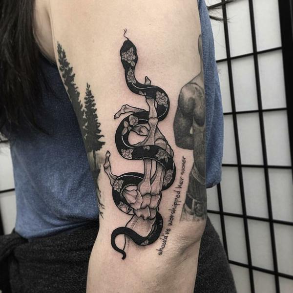 Skeleton hand entwined with a snake