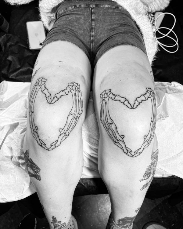 Skeleton hand heart tattoo 