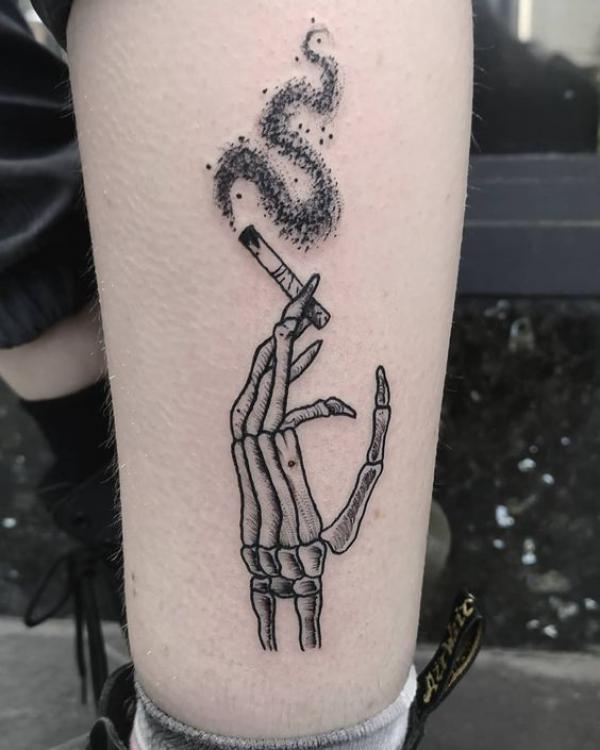 Skeleton hand holding a cigarette