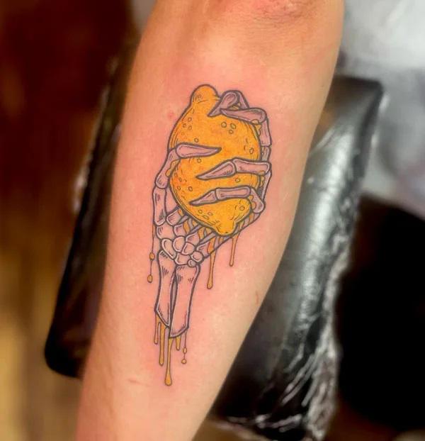 Skeleton hand holding a lemon