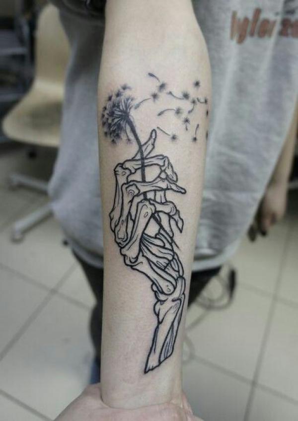 Skeleton hand holding dandelion
