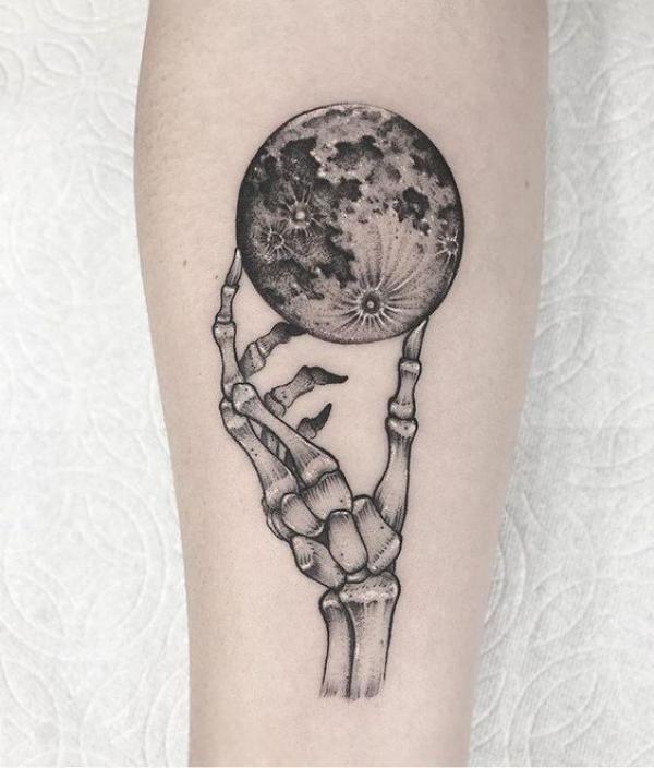 Skeleton hand holding the world