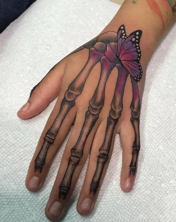 Skeleton hand with butterfly tattoo for female