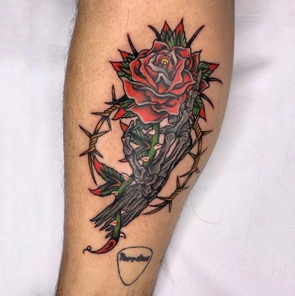 Skeleton hand with rose and barbed wire