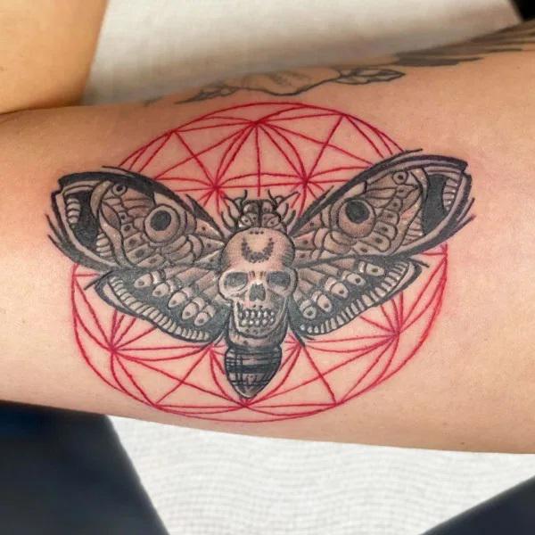Skull moth on flower of life background