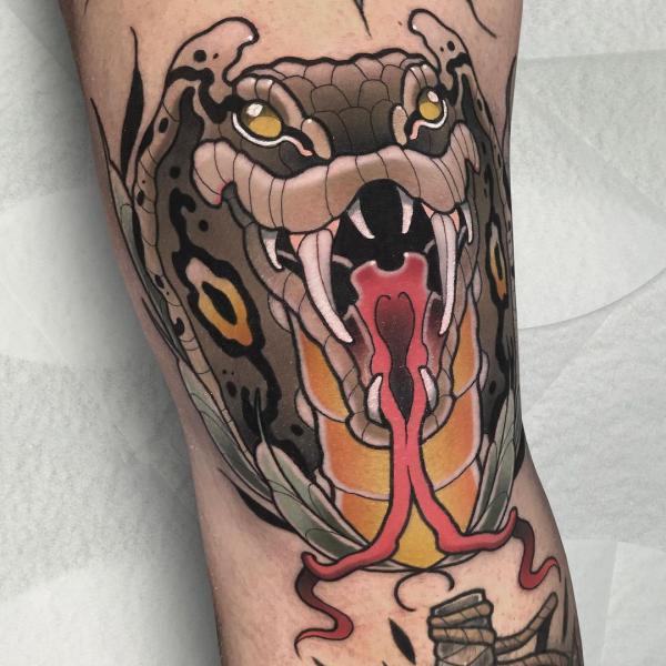 Snake head knee tattoo