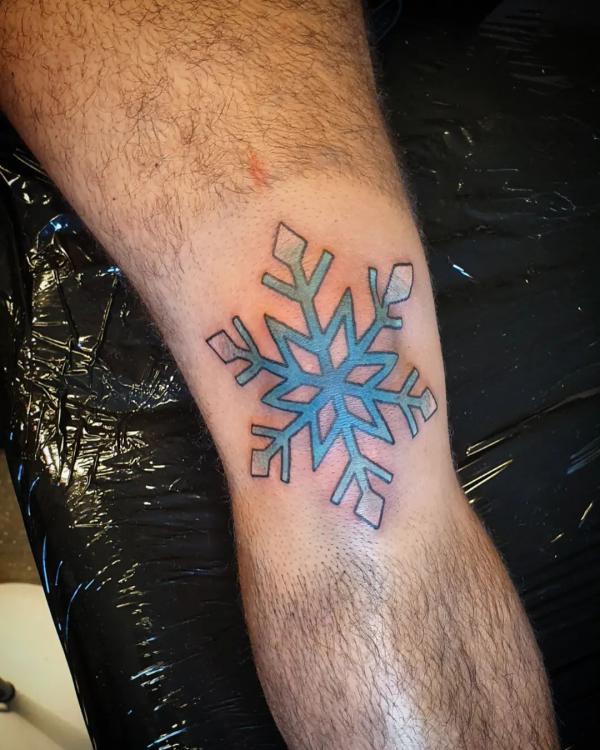 Snowflake tattoo on the knee
