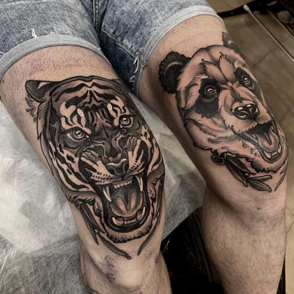 Tiger and bear heads above the knees