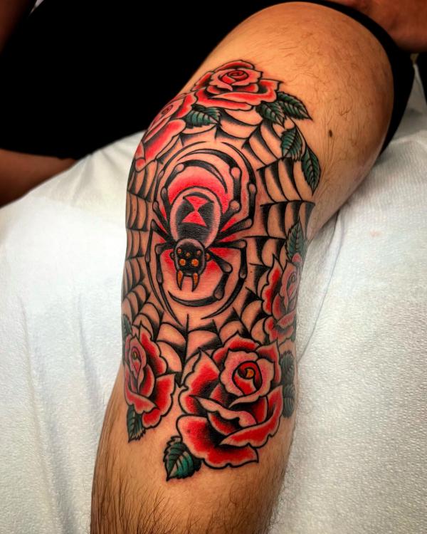 Traditional spider web and roses tattoo