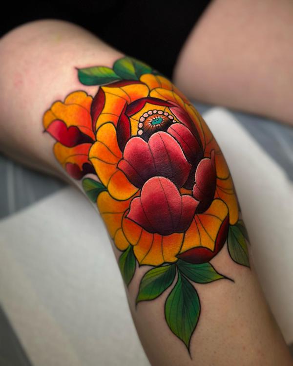 Traditional vibrant peony tattoo